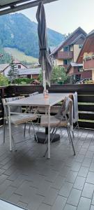 a table and chairs with an umbrella on a patio at Apartma 198 in Kranjska Gora