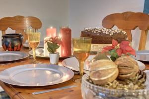 a table with plates and wine glasses and a cake at Harry's House (Muggles welcome too!) in Watford