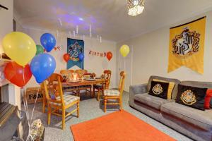a living room with a couch and a table with balloons at Harry's House (Muggles welcome too!) in Watford