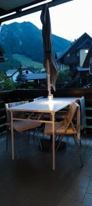 an umbrella sitting on top of a table with two chairs at Apartma 198 in Kranjska Gora