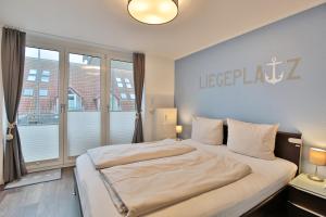 Postel nebo postele na pokoji v ubytování Strandduene Stranddüne Appartement 23