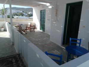 a balcony with a table and chairs and a view at Teresa Spiti in Adamantas
