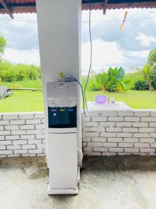 a white refrigerator sitting outside of a house at FAT MERMAID GUESTHOUSE in Pantai Cenang