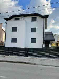 a white building on the side of a street at Apartmani Daisy in Velika Gorica