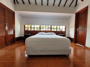 um quarto com uma cama grande num quarto em Hotel Chalet El Castillo by Majuva em Armênia