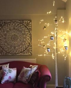 a christmas tree with lights on a wall at The Lodge at The Cedars in Stourbridge