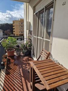 a wooden bench sitting on the porch of a house at La casa di Andrea in Messina