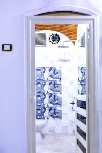 a bathroom with a toilet and a wall of shoes at Onaty Ka Guest House in Aswan +69 photos