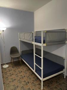 a room with two bunk beds and a chair at Agriturismo Graziano e Barbara in Porto Conte
