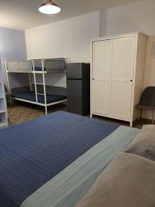 a bedroom with a bed and bunk beds and a cabinet at Agriturismo Graziano e Barbara in Porto Conte