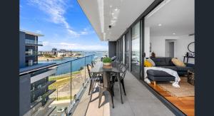 a room with a balcony with a view of the ocean at 3 Bedroom Sub Penthouse Apartment in the heart of Newcastle in Wickham