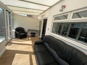 a living room with a couch and a chair at Wye Gardens 3 bedroom home with parking and garden in Nottingham