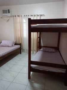 two bunk beds in a room with a window at Czarina Transient House in Alaminos