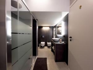 a bathroom with two toilets and a sink and a mirror at Milano Experience Home - Gauguin in Milan