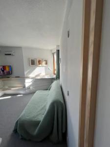 a bedroom with a green bed in a room at Modern studio in the heart of the station 1650 in Les Orres