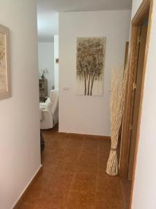 a hallway with a living room with a painting on the wall at Apartamento Talavera in Talavera de la Reina