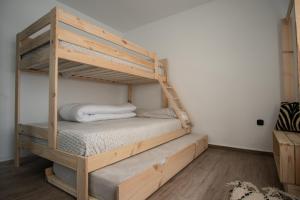 a wooden bunk bed in a room with a mattress at EDELWEISS HOUSE - Parking y Wifi GRATIS in Sierra Nevada