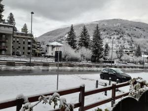 a car parked in a parking lot covered in snow at Einaudi 9 in Bardonecchia