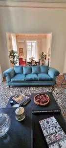 a blue couch in a living room with a table at La Renaissance in Catania