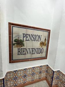 a sign on a wall that reads pension bernheim at Pensión Bienvenido in Seville