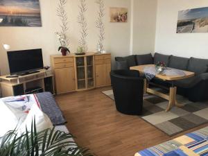 a living room with a couch and a table at Ferienwohnung Sprenger _ Objekt 25 in Rostock