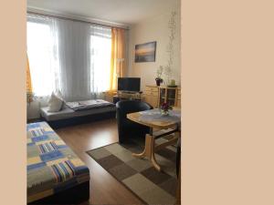 a living room with a couch and a table at Ferienwohnung Sprenger _ Objekt 25 in Rostock