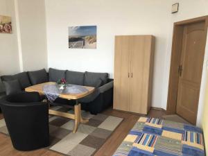 a living room with a couch and a table at Ferienwohnung Sprenger _ Objekt 25 in Rostock