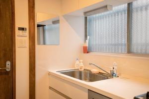 a kitchen with a sink and a window at Tofukuji Saku Inn（东福寺咲く宿） in Kyoto