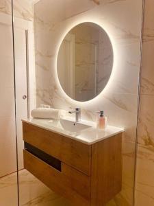a bathroom with a sink and a mirror at PARQUE SANTIAGO I Stunning brand new apt 2 bedroom Playa de las Américas in Playa de las Americas