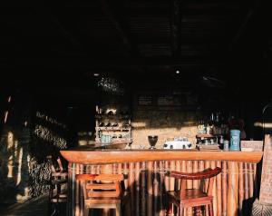 a bar with two stools and a counter with wine bottles at Lua Pu Luong in Pu Luong