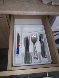 a drawer with silver utensils in a cabinet at Дом рядом проспекта Исакова, 3 км Звартноц аэропорт EVN in Geghanist