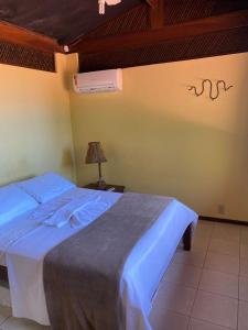 Cama ou camas em um quarto em Chalés Mirante de Pipa
