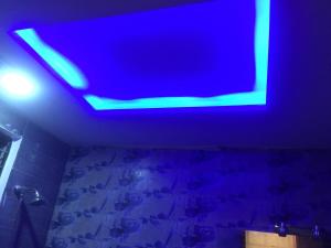 a bathroom with a blue light on the ceiling at Continental Girls Hostel UCP in Lahore