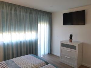 Televízia a/alebo spoločenská miestnosť v ubytovaní Apartamento con estupendas vistas