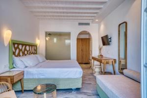 a hotel room with a bed and a couch at San Antonio Summerland in Mikonos