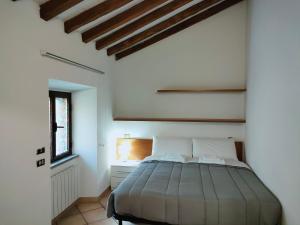 a bedroom with a bed in a white room at Francigena Viterbo Apartment in Viterbo