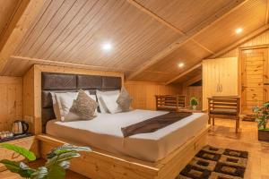 a bedroom with a bed in a wooden room at The Kufri Uphills in Shimla