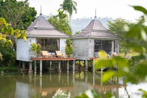 a house in the middle of a body of water at Anodard Phuket, Nai Yang Beach in Thalang