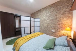 a bedroom with a bed and a brick wall at Artistic Digital Retreat-Great Location Near Metro in Valencia