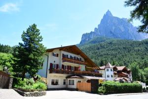 a large building with a mountain in the background at Haus Fulterer in Siusi