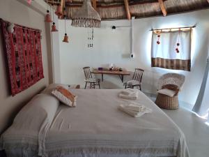 a bedroom with a large bed and a table at Tierra de Inmigrantes in Baradero