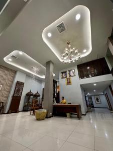 a person sitting at a desk in a lobby at August Residence in Bangkok