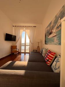 a bedroom with a large bed and a television at Casa Le Grazie V Battisti nr 141 Portovenere in Le Grazie