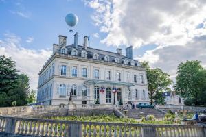 a large white building with a hot air balloon in the sky at Champagne stars in Épernay