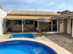 ein Swimmingpool vor einem Haus in der Unterkunft Casa Águas de São Pedro in Águas de São Pedro