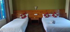 Voodi või voodid majutusasutuse Hotel hornbill toas