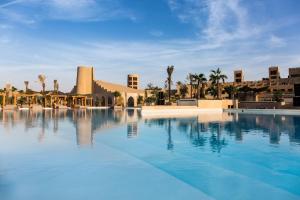 a large swimming pool in front of a resort at Terra Solis Dubai in Dubai