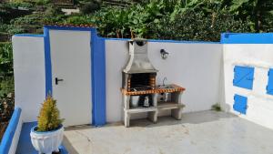 a small stove on the side of a white wall at Casa Marcos in La Gomera with relaxing terrace in Agulo