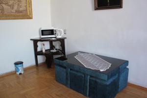 a black ottoman sitting in a room with a microwave at 21 На удачу in Rustavi