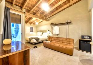 a living room with a couch and a bed at Blue Sardine Hostal Boutique Altea in Altea